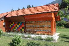 Slovenian bee house with painted front panels